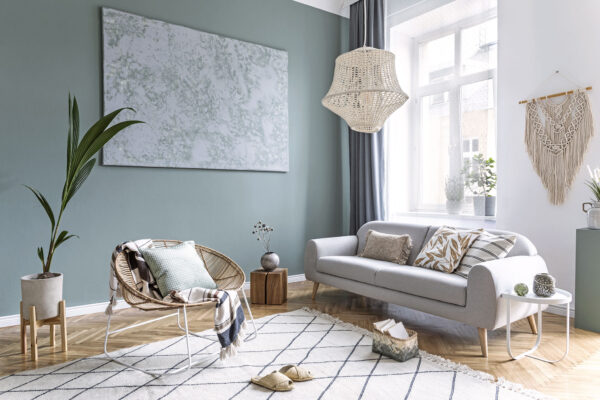Boho style living room with macrame, rattan armchair and sofa